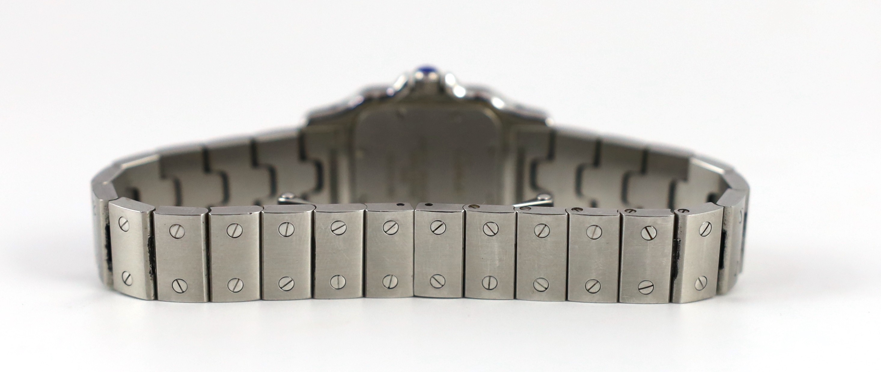 A lady's stainless steel Cartier Santos quartz wrist watch, on a stainless steel Cartier bracelet